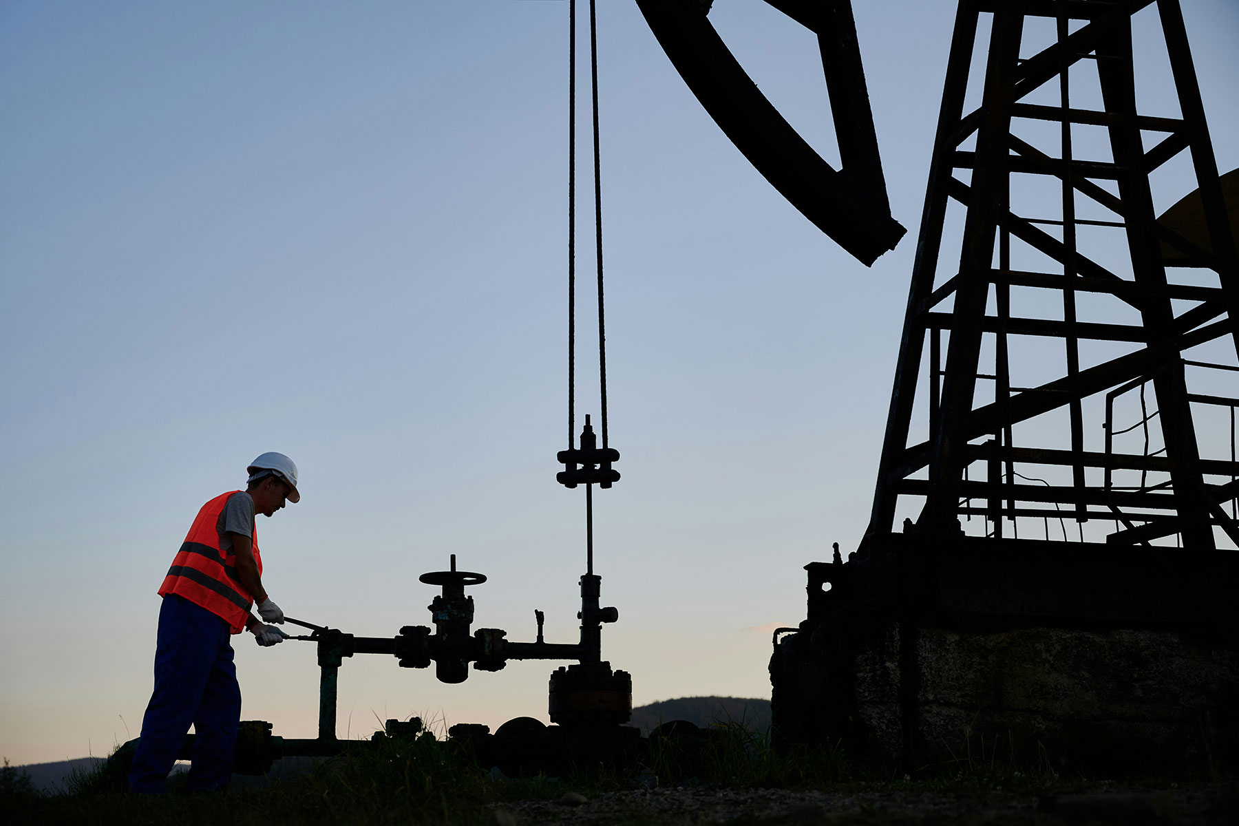 worker on oil rig at dusk